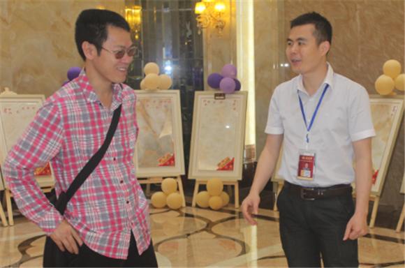 20140530204316948 今年会jnh网络营销主管王宏城(右一)向记者介绍微晶瓷片